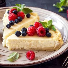 two slices of cheesecake with fresh berries on top