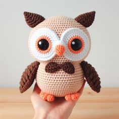 a crocheted owl with big eyes and a mustache on it's head