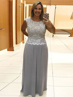 a woman taking a selfie with her cell phone wearing a dress and lace top