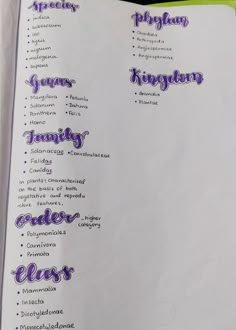 an open book with purple writing on it