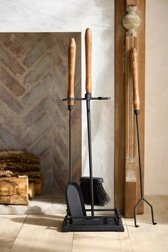 two brooms are standing next to each other in front of a fireplace