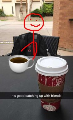 a cup of coffee sitting on top of a table next to a person with a red marker