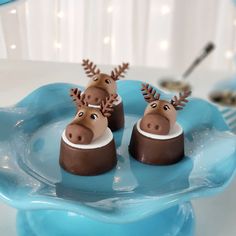 two chocolate moose candies on a blue plate