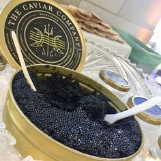 the caviar company logo is on top of some black cavias in a bowl