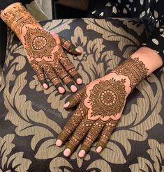 two hands with henna designs on them