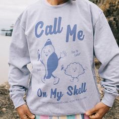 Men's printed sweatshirt with “Call Me On My Shell” slogan and vintage style shell character graphics. Shellebrate summer in this retro beach slogan sweater. Slouchy fit. This item makes a great gift and it's a must-have for your summer staycation. All Batch1 products are lovingly designed, printed and packed by hand in the UK at Batch1 HQ.  Our garments are made to order to minimise wastage and printed using water-based, eco-friendly inks. We are committed to creating on-trend, environmentally Funny Print Cotton Sweatshirt For Streetwear, Cotton Sweatshirt With Funny Print For Streetwear, Retro Cotton Sweatshirt With Funny Print, Retro Cotton Sweatshirt With Graphic Print, Retro Cotton Sweatshirt With Slogan, Vintage Cotton Sweatshirt With Slogan, Slogan Sweater, Summer Staycation, Women Slogan