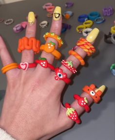 a person's hand with many rings on it and various bracelets around their fingers