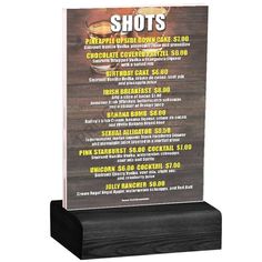 a wooden plaque with the words shots on it and an image of a hot dog