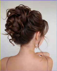 the back of a woman's head, with her hair in a low bun