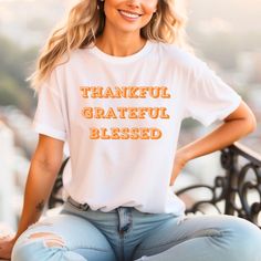 A thankful, grateful, blessed unisex shirt perfect for the holiday season, especially Thanksgiving. This shirt exudes warmth and positivity, making it a great gift for him or her. It fits seamlessly into a casual or semi-formal setting, offering a classic style that is easy to layer and breathable. Made with 100% Airlume combed and ring-spun cotton, it is lightweight and perfect for active and leisure wear. Product features - With side seams for structural support - Ribbed knit collar with seam for shape retention - Shoulder tape for stabilization - DTF inner neck labels for comfort - Retail fit for casual and semi-formal settings Care instructions - Machine wash: cold (max 30C or 90F) - Non-chlorine: bleach as needed - Tumble dry: low heat - Iron, steam or dry: medium heat - Do not drycle Grateful Shirt, Blessed Shirt, Thankful Grateful Blessed, Grateful Thankful Blessed, Thanksgiving Holiday, Knit Collar, Leisure Wear, Unisex Shirt, Holiday Spirit