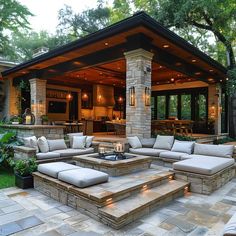 an outdoor living area with couches and fire pit