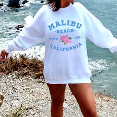 Very trendy Malibu beach crewneck sweatshirt, throw it over a bikini on those cool nights. Have a look around my shop to see what else you'll love! https://www.etsy.com/uk/shop/ApparelByAntonia?ref=seller-platform-mcnav ♦️ THE PRODUCT ♦️ Likely to become your new favourite! This all season pullover sweatshirt is perfect for those cool nights. Made with tough construction that is built for the outdoors and super soft fabric that is perfect for a snuggle on the couch. It would make a great additio Trendy Long Sleeve T-shirt For Beach, Summer Crew Neck Sweatshirt For Streetwear, Sporty Long Sleeve Beach Tops, Sporty Long Sleeve Tops For Beach, Relaxed Fit Long Sleeve Beach T-shirt, Oversized Crew Sweatshirt For Summer, Graphic Print Long Sleeve Tops For Beach Season, Long Sleeve Graphic Print Tops For Beach Season, Sporty Long Sleeve Tops For Beach Season