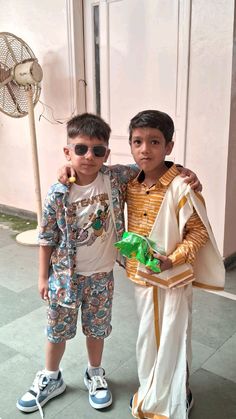 two young boys standing next to each other