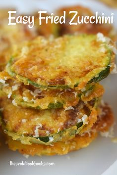 three fried zucchini stacked on top of each other with text overlay that reads easy fried zucchini