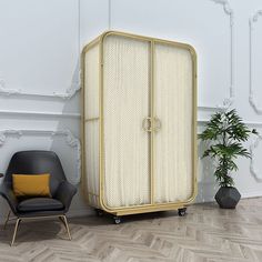 a white and gold armoire next to a black chair