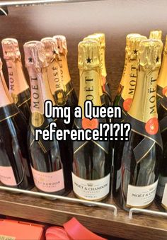 several bottles of champagne sitting on top of a shelf next to each other with the words omg a queen reference??