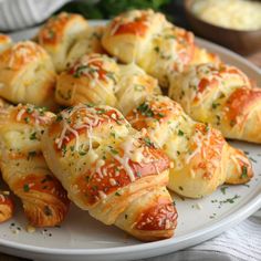 a white plate topped with cheesy bread rolls