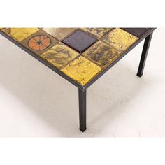 a table made out of different colored tiles