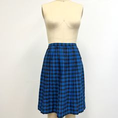 Vintage plaid wool pleated skirt featuring; a high waisted cut with a 1 inch waist band this is pleated and slightly flared has a metal zipper and single snap at the side of the waist hem falls to the knee Of a smooth, mid weight wool in a small plaid of aqua, black, and brown on royal blue. With no labels or tags, this appears to be handmade vintage, measurements when laid out flat are; 14 inches at the waist hips are free 24 inches from waist to hem 2 inch hem In good, preworn, vintage condition with no major holes, stains, or funky odors....we did find one tiny hole on the front...it is hard to see when worn and price is reflective of this. We are happy to ship internationally and combine shipping. Retro Pleated School Bottoms, Retro Pleated Bottoms For School, Retro Pleated Skirt For Daywear, Retro Plaid School Bottoms, Vintage Plaid Pleated Skirt, Vintage Pleated Plaid Skirt, Vintage Plaid Skirt For School, Retro Plaid Full Skirt, Retro Full Skirt In Plaid