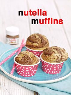 three muffins sitting on top of a blue and white plate with pink polka dots