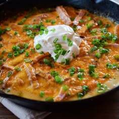 a skillet filled with food on top of a wooden table