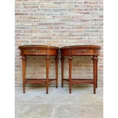 two wooden tables sitting side by side against a brick wall