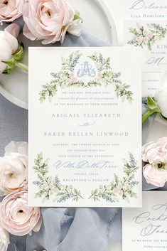 the wedding stationery is laid out on top of each other with pink flowers and greenery