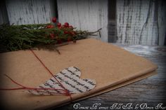 an old book is wrapped in brown paper and tied with red twine on top