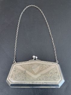 Vintage silver plated coin purse with short chain, patterned to front, plain to back except for patterned border, wear to back with loss of finish (shown in pictures), stains to green lining  - see all pictures. Size is approximately (external) 12.3 cms x 7 cms (including clasp) x 2.7 cms, weight is approximately 105 g. Vintage Silver Rectangular Coin Purse, Silver Rectangular Coin Purse For Wedding, Silver Rectangular Coin Purse For Evening, Formal Silver Engraved Bags, Elegant Silver Rectangular Coin Purse, Coin Purses, Purse Pouch, Antique Collection, Wall Collage