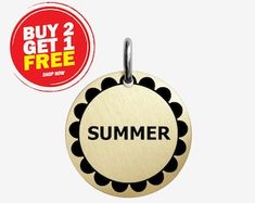 a round metal tag with the word summer printed on it next to a buy 2 get 1 free sticker