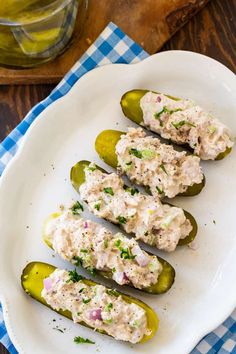 stuffed jalapenos on a white plate with a blue and white checkered napkin