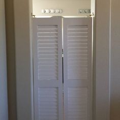 an open door with white shutters in a room