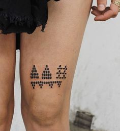 a woman's legs with black dots on them and the word love written in it