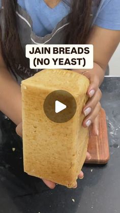 a woman holding a piece of bread with the words jain breads no yeast