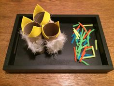 a dog is sitting on a tray with some crafting materials in front of it