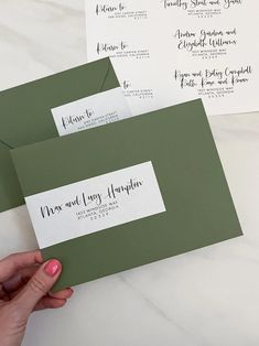 two green envelopes with white paper on them, one has a handwritten message