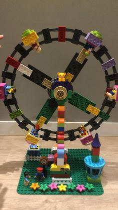 a toy ferris wheel with legos all around it