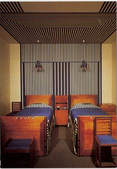 two beds in a room with striped walls