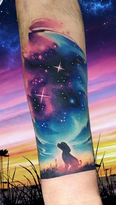 a man's arm with a dog and stars in the night sky on it