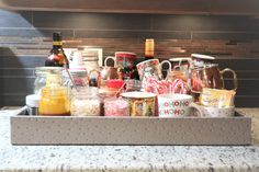 a tray filled with cups and sauces on top of a counter