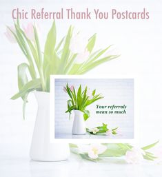 a white vase filled with pink flowers next to a card that reads, your refer thank you postcards