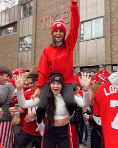 two girls in red and white cheer for their team