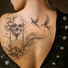 the back of a woman's shoulder with a tattoo on it and a bird