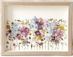 an image of flowers in a wooden frame