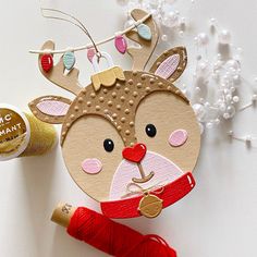 a craft kit with yarn, thread and an ornament to make a reindeer decoration