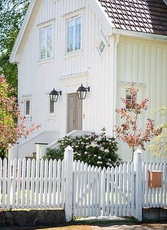 a white house with a picket fence around it