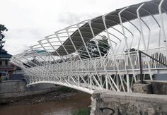 a large white bridge spanning over a river