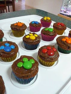 cupcakes with chocolate frosting and candy on top