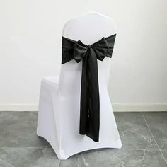 a white chair with a black bow on it