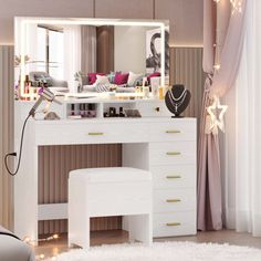 a bedroom with a vanity, mirror and lights on it's side table in front of a window